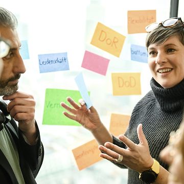 Woman with Post-Its, speaking in front of other people