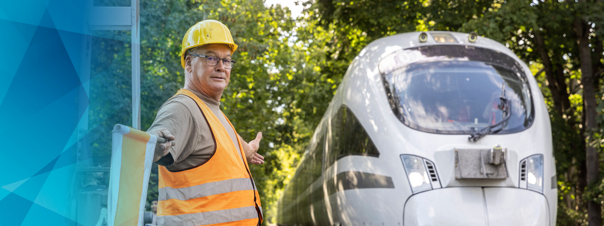 Man in high-visibility waistcoat shows passing train the way with flag