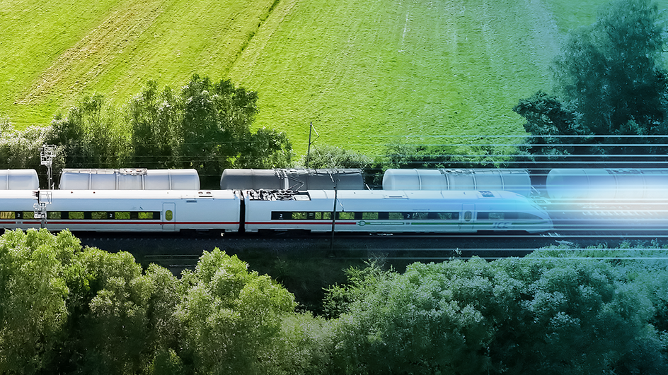 A goods train and an ICE travelling through green countryside