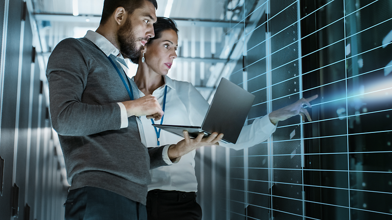 Man and woman with laptop in business outfit