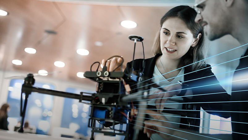 Woman and man looking at drone exhibit