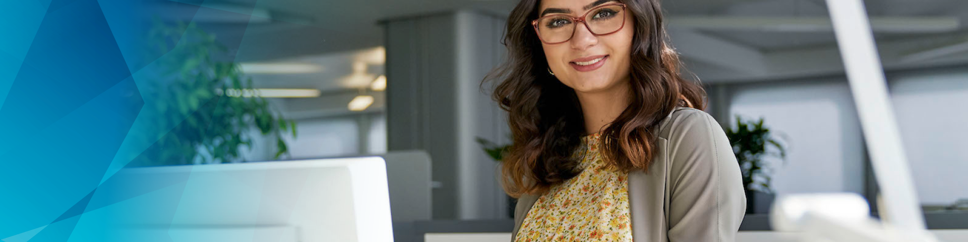Young woman with glasses and yellow shirt in an office