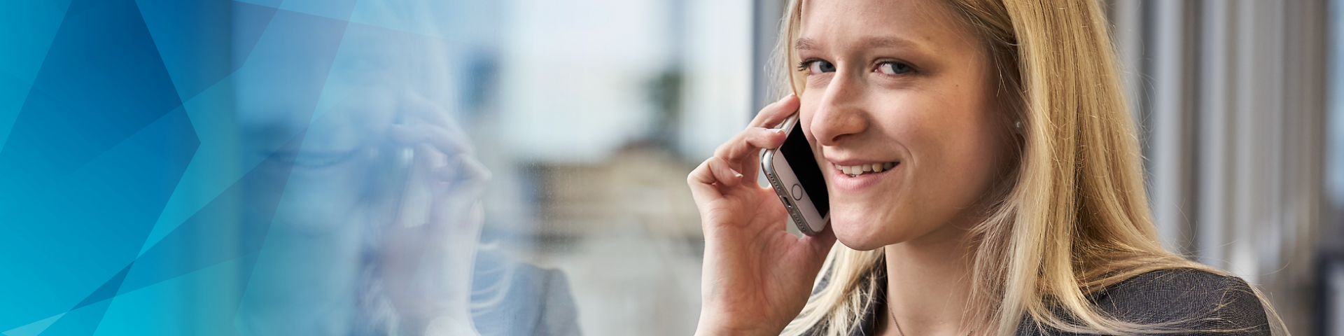 Woman on the phone at a window in the office