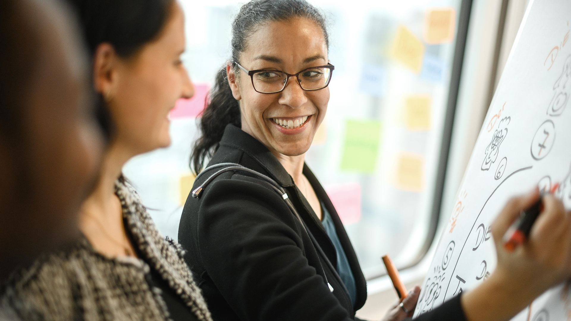 Woman writing on whiteboard