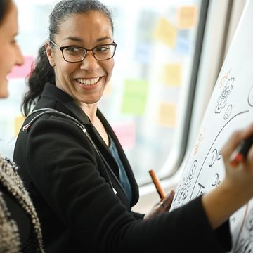 Woman writing on whiteboard