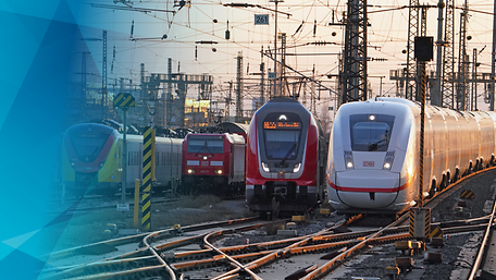 Verschiedene Züge nebeneinander bei der Einfahrt in einen Bahnhof