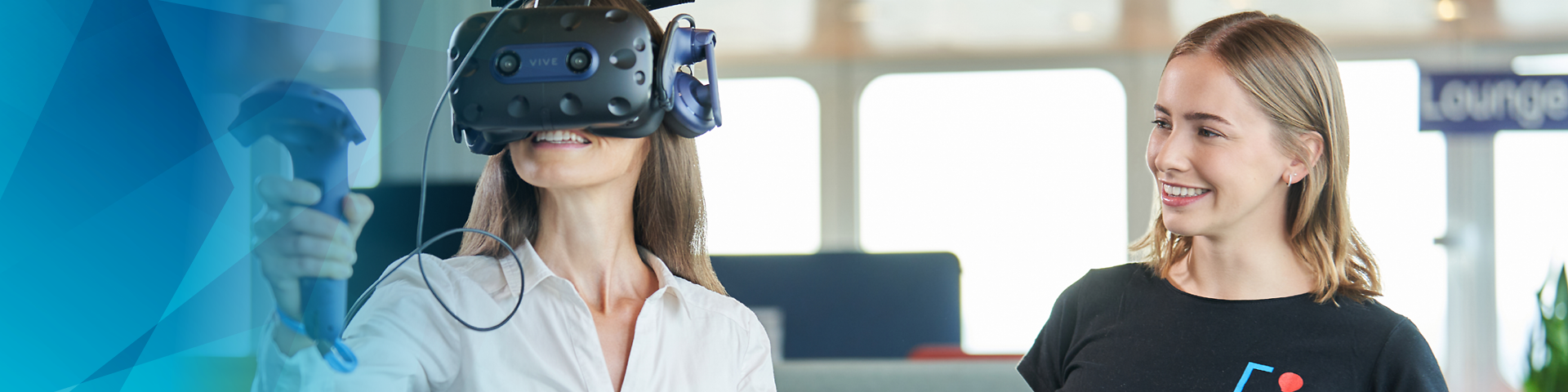 Woman with VR glasses next to woman with tablet