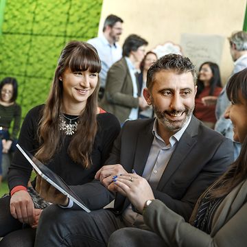 Employees in a meeting with tablet in hand