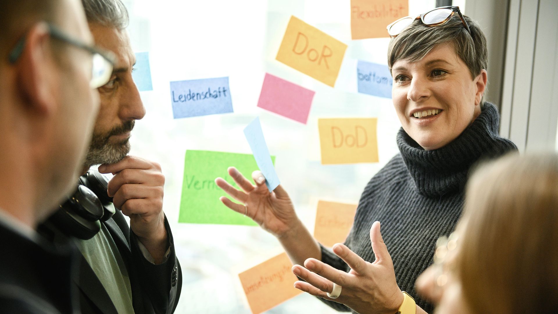 Woman with Post-Its, speaking in front of other people